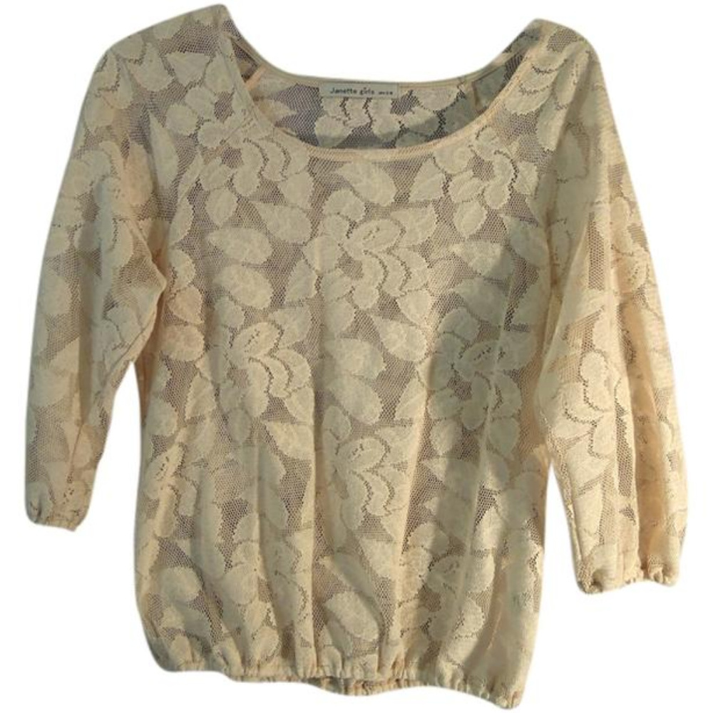 Ivory lace top with floral design.